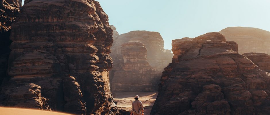 a man standing in the middle of a desert